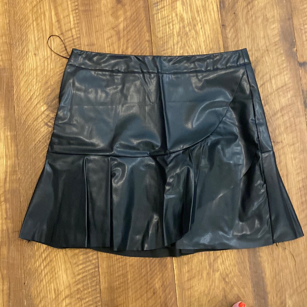 Black faux leather skirt with ruffle bottom